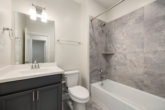 full bathroom with vanity, toilet, and tiled shower / bath