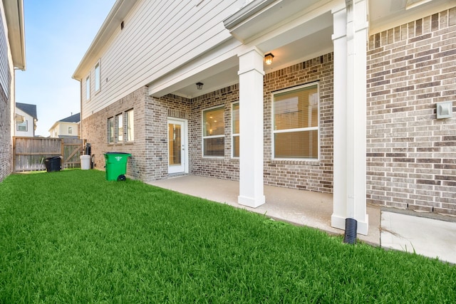 rear view of house with a yard and a patio