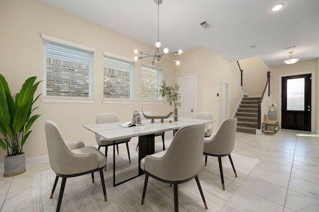 dining area with plenty of natural light and an inviting chandelier