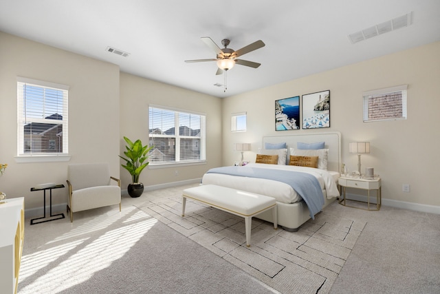 bedroom featuring light colored carpet and ceiling fan