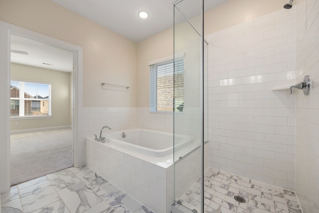 bathroom featuring separate shower and tub and a wealth of natural light