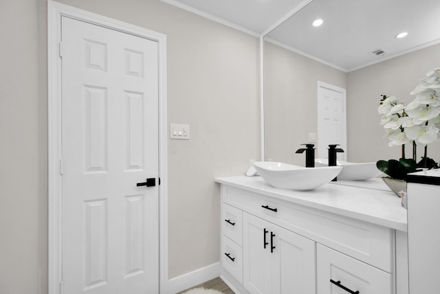 bathroom with crown molding and vanity