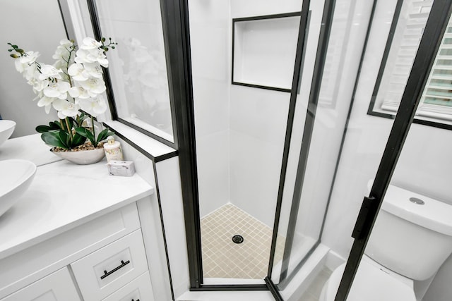 bathroom with vanity, toilet, and walk in shower