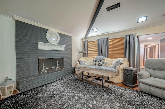 living room featuring lofted ceiling with beams and a fireplace