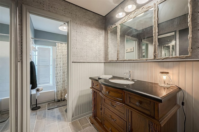 full bathroom featuring vanity, toilet, and shower / bathtub combination with curtain