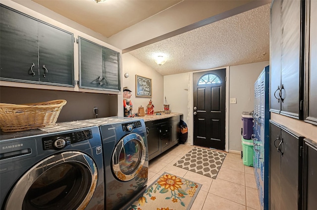 clothes washing area with cabinets, a textured ceiling, separate washer and dryer, and light tile patterned flooring