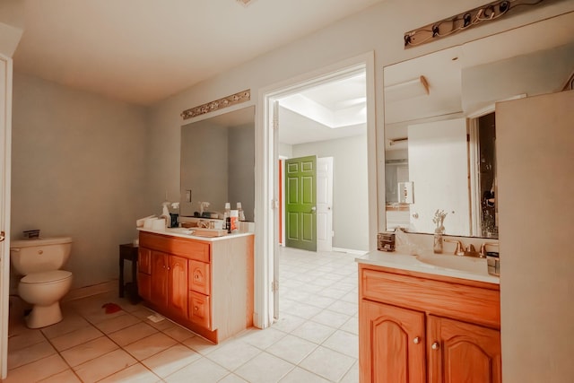 bathroom featuring tile patterned floors, vanity, and toilet