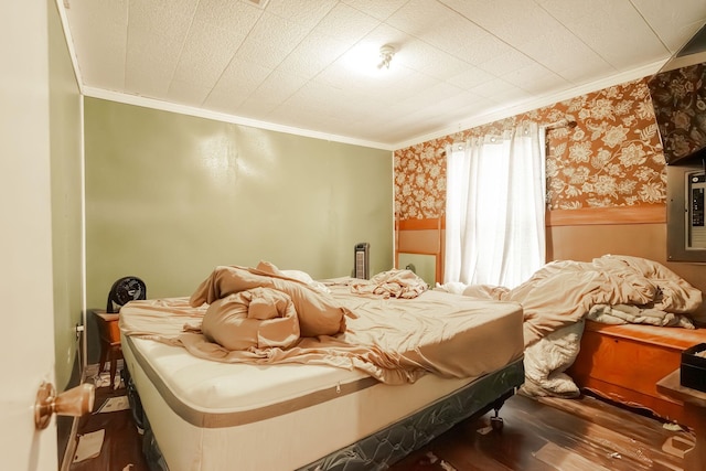 bedroom with ornamental molding and hardwood / wood-style flooring