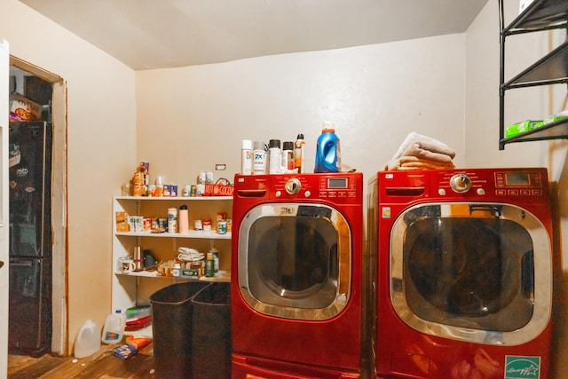 clothes washing area with hardwood / wood-style floors and separate washer and dryer