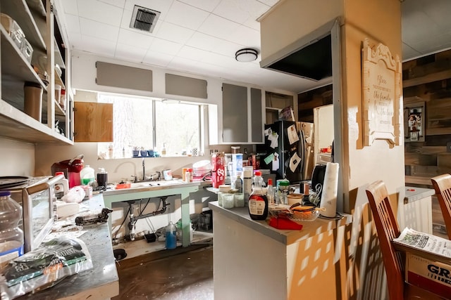 kitchen with black fridge with ice dispenser