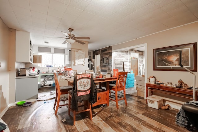 dining room with hardwood / wood-style flooring and ceiling fan