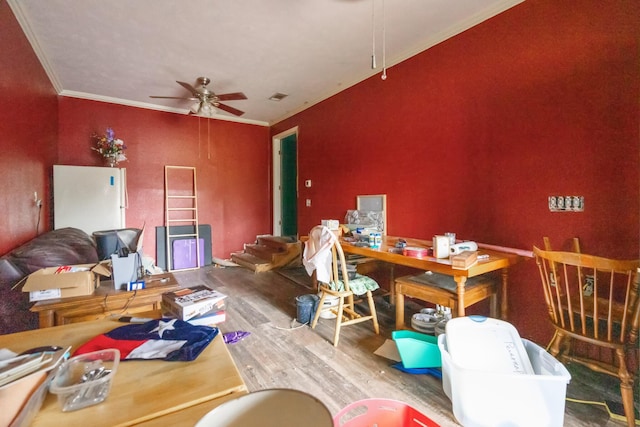 dining room with wood-type flooring, ceiling fan, and ornamental molding