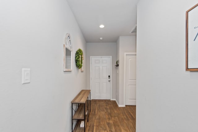 hall featuring recessed lighting, visible vents, baseboards, and dark wood finished floors