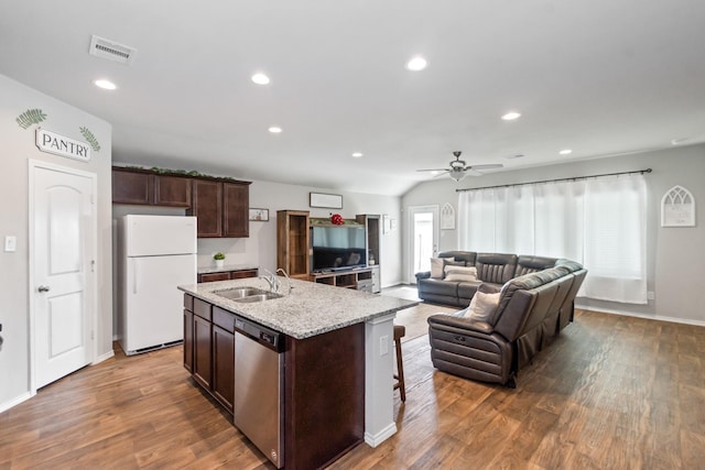 kitchen with dark brown cabinetry, dishwasher, freestanding refrigerator, wood finished floors, and a sink