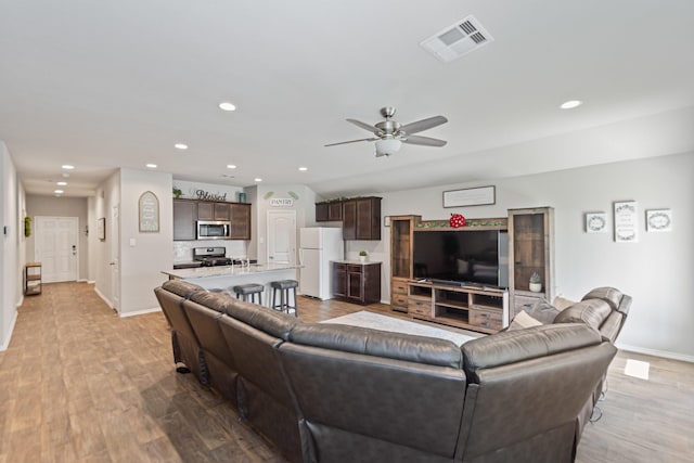 living area featuring recessed lighting, visible vents, light wood finished floors, and ceiling fan