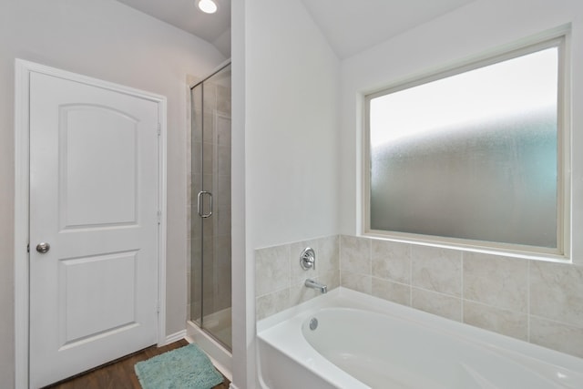 full bath with a shower stall, a garden tub, and wood finished floors