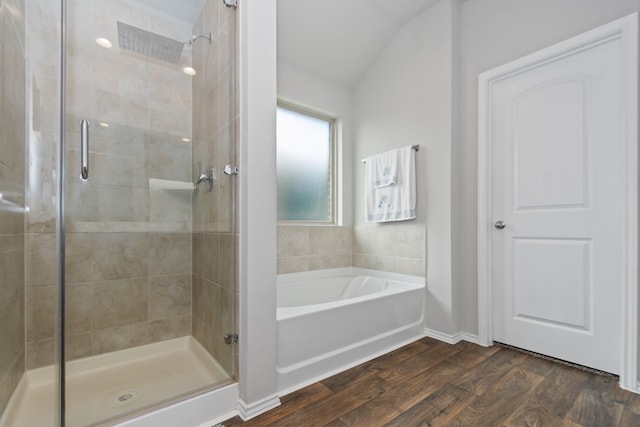 full bath with lofted ceiling, a garden tub, wood finished floors, and a shower stall