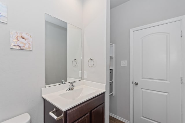 half bath with vanity and toilet