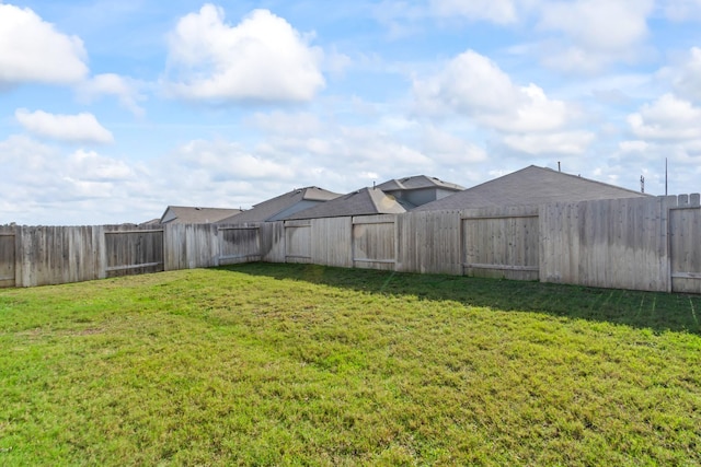 view of yard with a fenced backyard