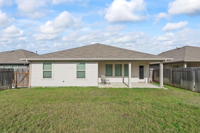 back of house featuring a patio, a fenced backyard, and a lawn