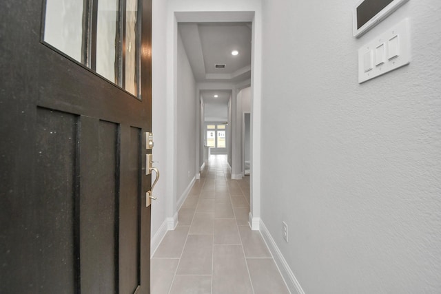 corridor with light tile patterned floors