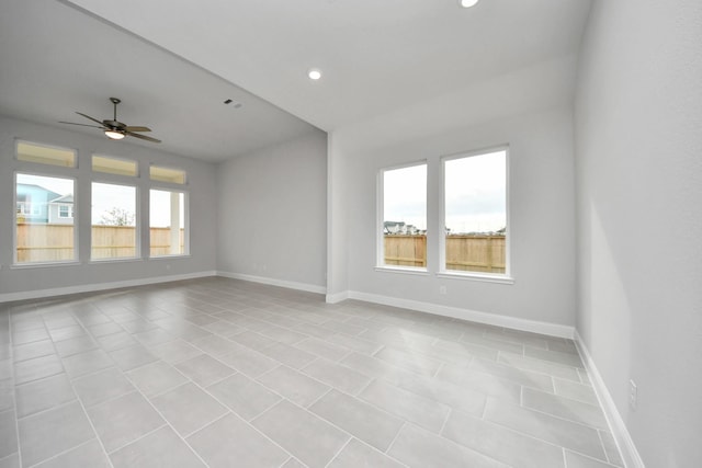 empty room with ceiling fan, recessed lighting, a wealth of natural light, and baseboards