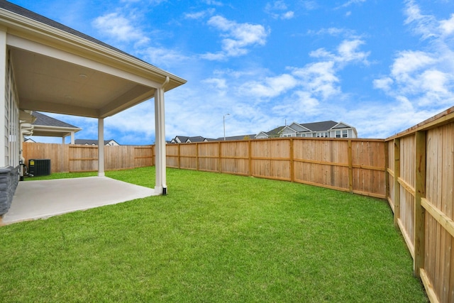 view of yard featuring central AC, a patio area, and a fenced backyard