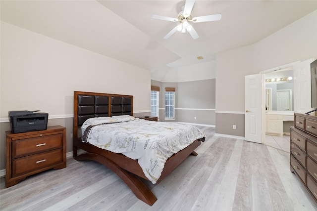 bedroom featuring connected bathroom, ceiling fan, light hardwood / wood-style floors, and lofted ceiling