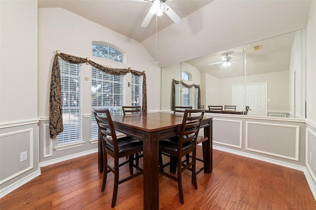 dining space featuring hardwood / wood-style flooring, vaulted ceiling, and ceiling fan