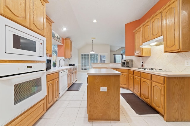 kitchen with a center island, kitchen peninsula, lofted ceiling, decorative light fixtures, and white appliances