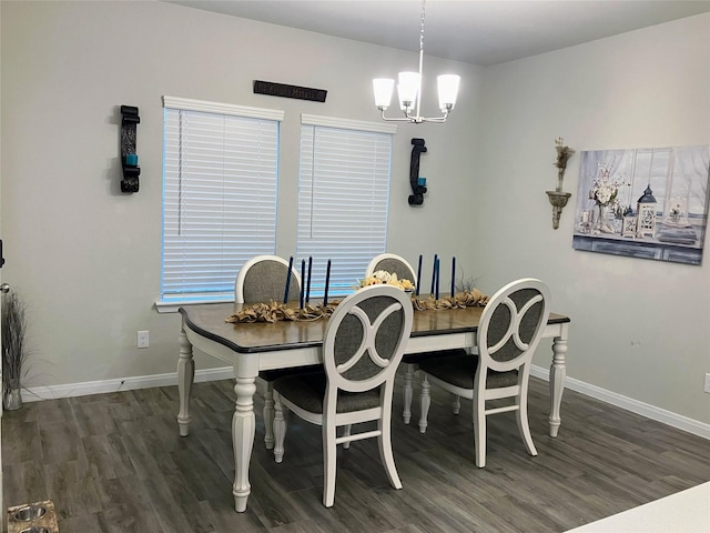 dining area with dark hardwood / wood-style flooring and a chandelier