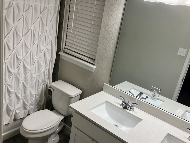 full bathroom featuring vanity, shower / tub combo, and toilet