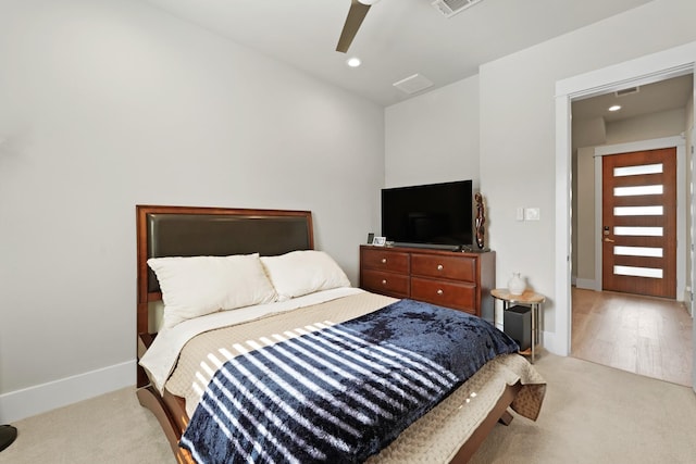 bedroom featuring light carpet and ceiling fan