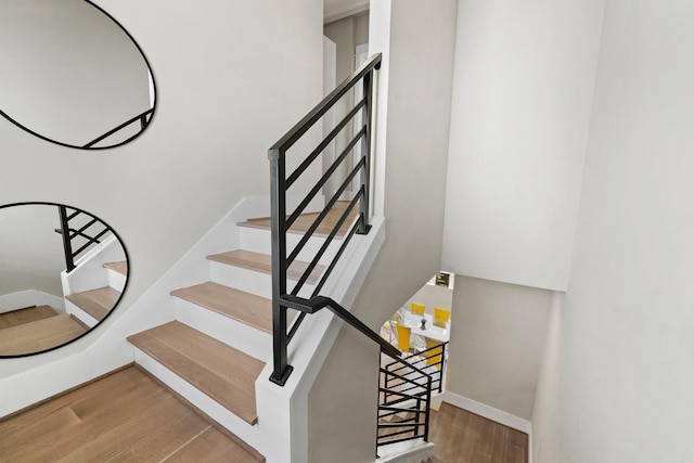 stairs featuring wood-type flooring