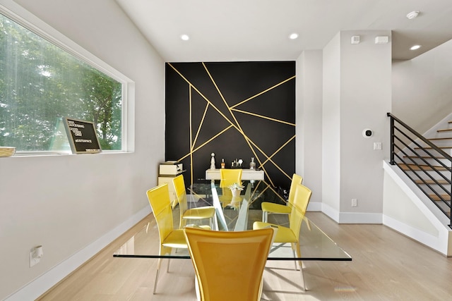 dining room with a healthy amount of sunlight and light hardwood / wood-style flooring