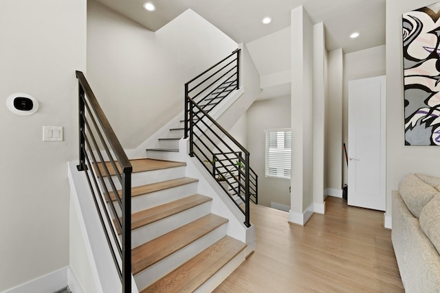 stairs with hardwood / wood-style floors