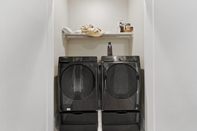 clothes washing area featuring washer and dryer