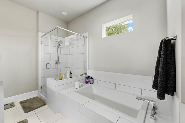 bathroom featuring tile patterned floors and separate shower and tub