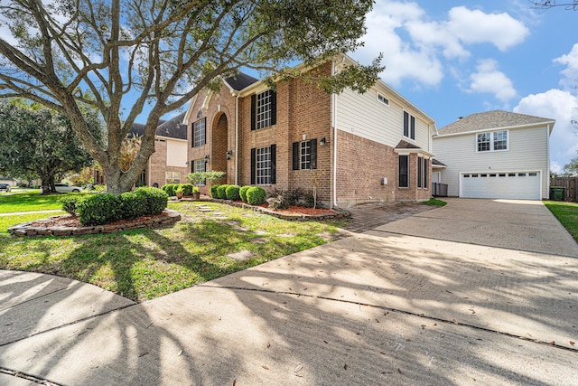 view of property featuring a front lawn and a garage