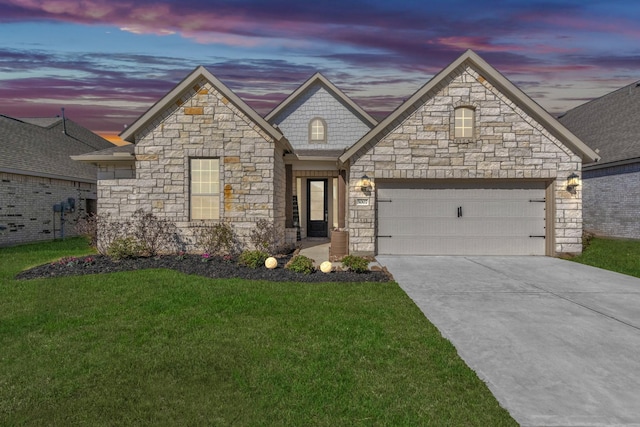 view of front facade with a yard and a garage