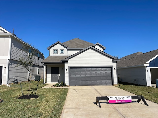 view of front of home featuring a front yard and a garage