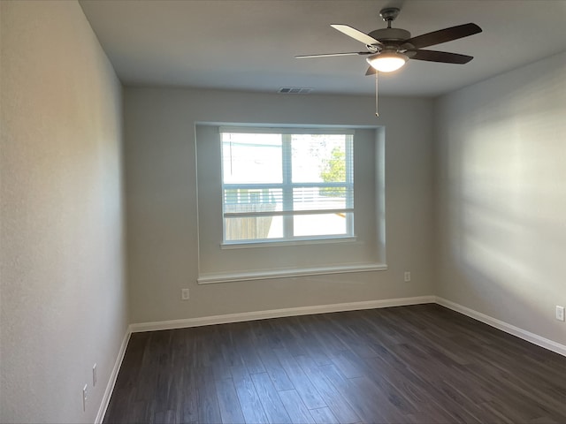 unfurnished room with dark hardwood / wood-style flooring and ceiling fan