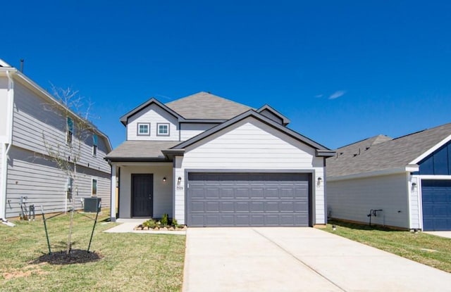 traditional home with a front yard, driveway, roof with shingles, central AC, and a garage