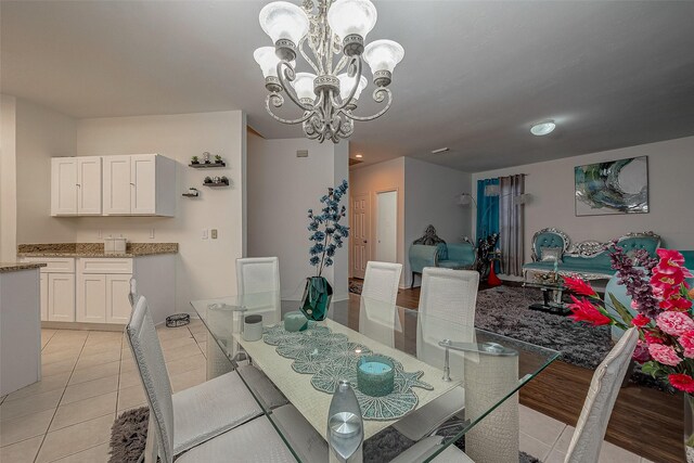 dining area featuring light tile patterned floors and a chandelier