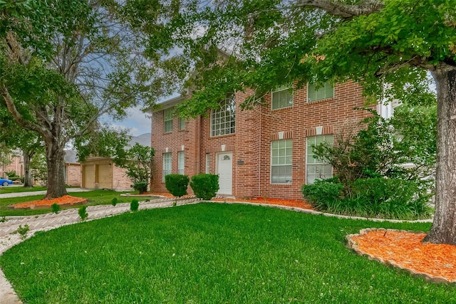 colonial inspired home with a front lawn