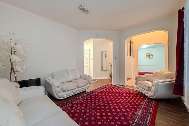 living room with crown molding and hardwood / wood-style floors