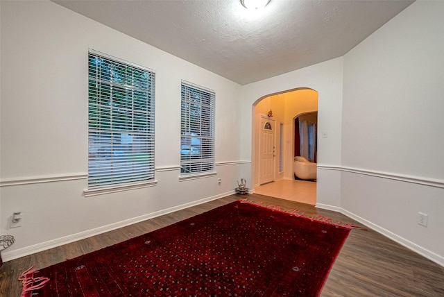 empty room featuring hardwood / wood-style flooring and a textured ceiling