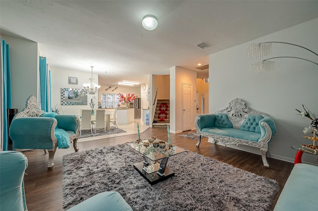 living room with dark wood-type flooring and a chandelier