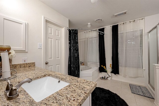 bathroom featuring tile patterned floors, vanity, and a textured ceiling