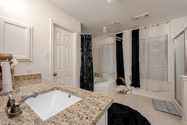 bathroom featuring tile patterned floors, a textured ceiling, and vanity